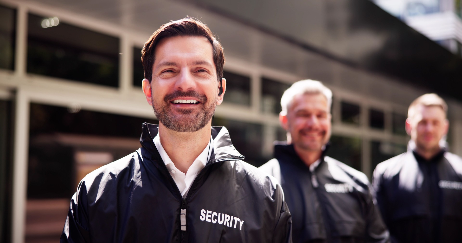 Professional Security Officer Supervising Bodyguards at Event